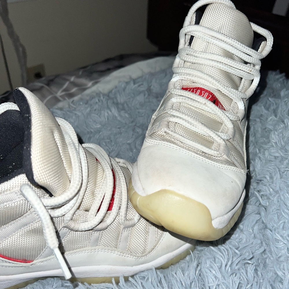 Slightly worn Jordan 11 platinum tint